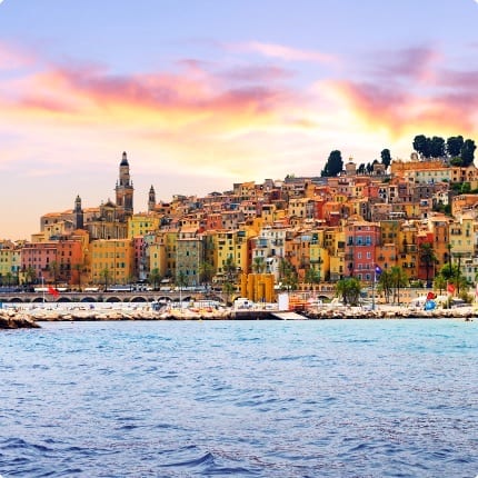 Panoramic view of Cannes from above showing La Croisette promenade, sandy beach, and yachts in the bay